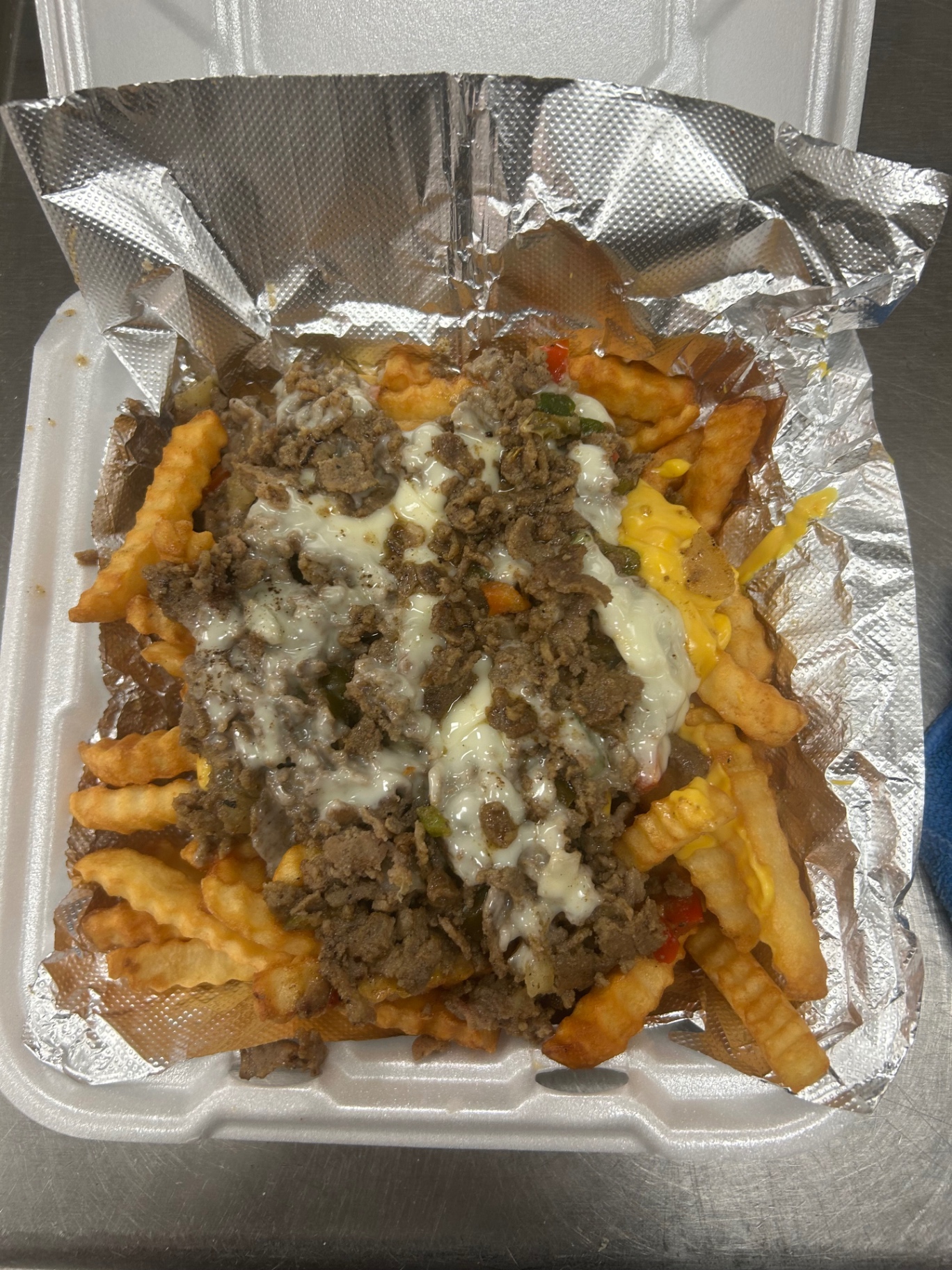 Crinkle fries loaded with chopped steak, peppers and melted cheese